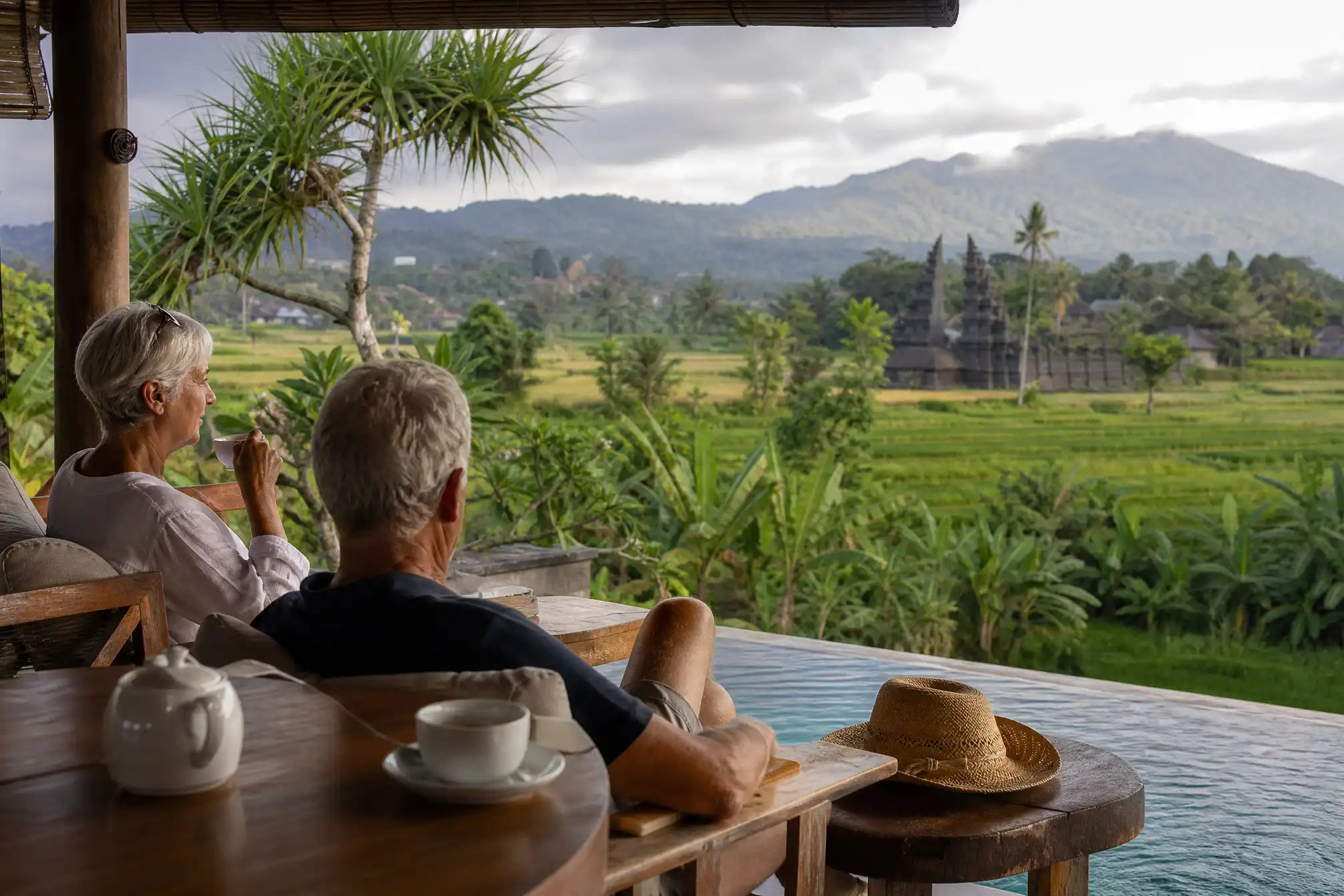 Australian retired couple on a Bali villa terrace with rice fields