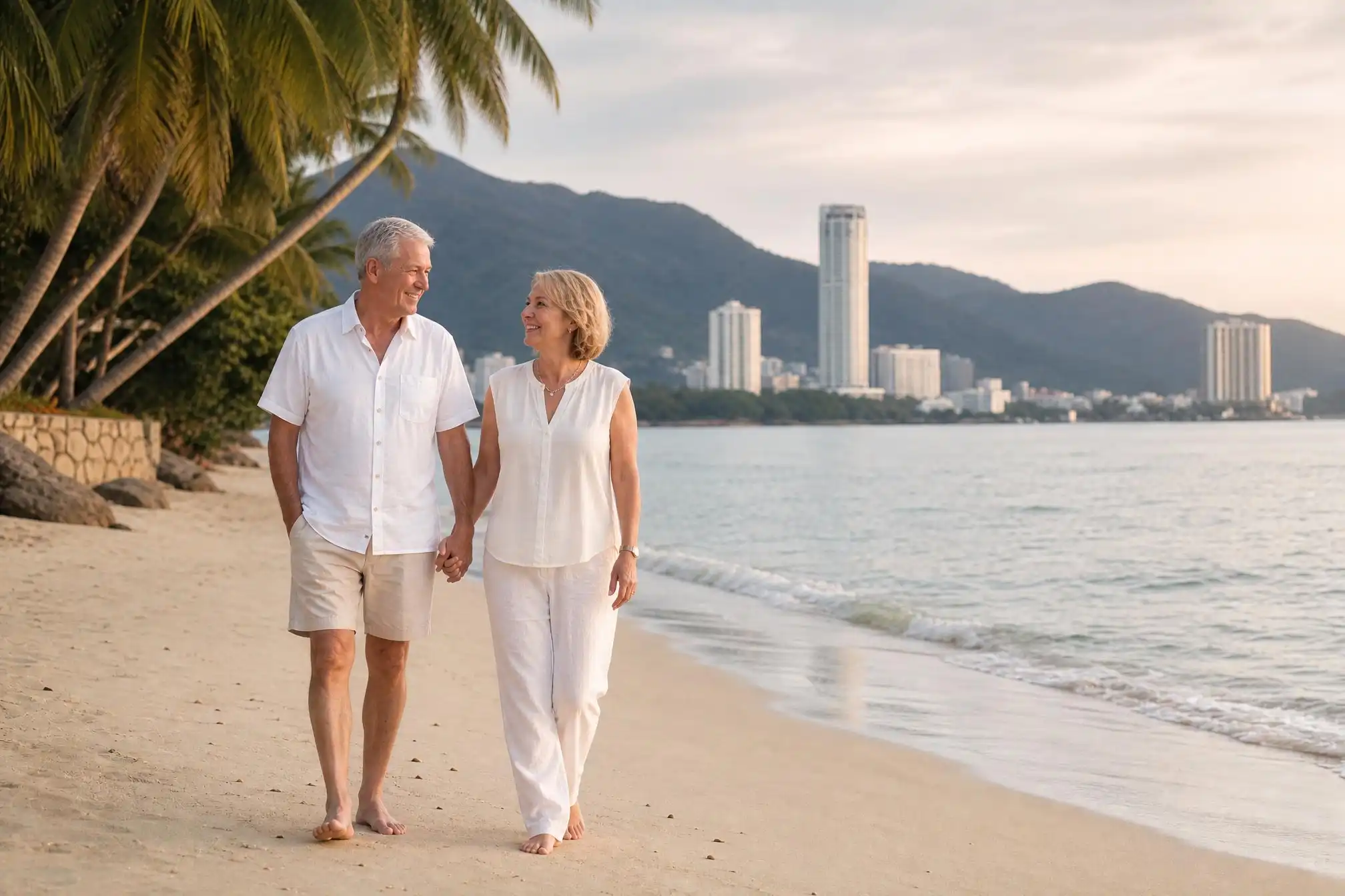 Australian retired couple walking on Penang beach