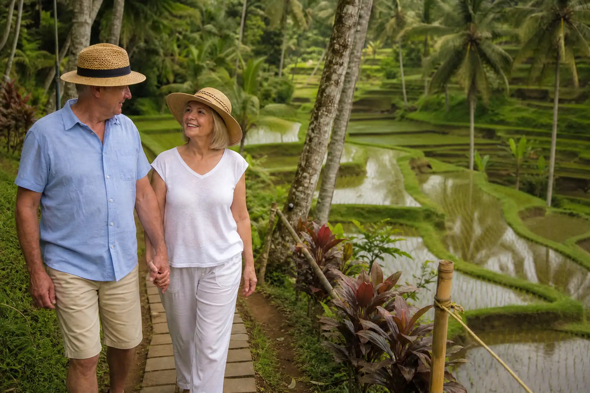 Australian retired couple walking through Ubud rice terraces