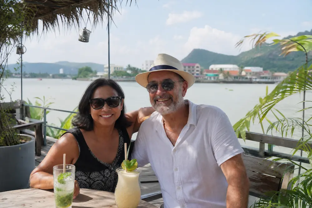 Diverse Australian retired couple at Kampot riverside Cambodia