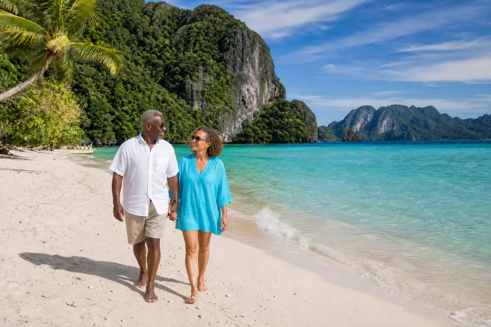 Retired couple on Palawan beach in the Philippines